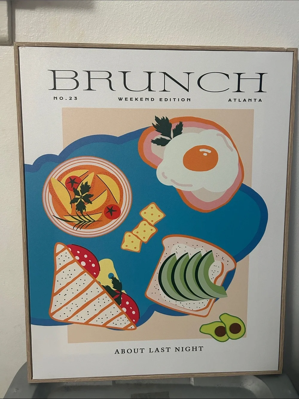 Ashland canvas wall art Brunch Weekend Edition Framed on a light wood-toned